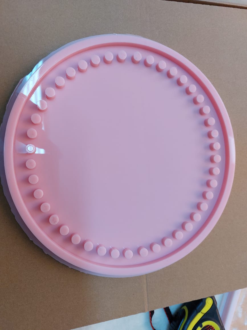 Silicone mold. The mold is round and has an internal pattern consisting of a series of small raised circles evenly distributed around the inner perimeter. Diameter: 15 cm, Depth: 8 mm