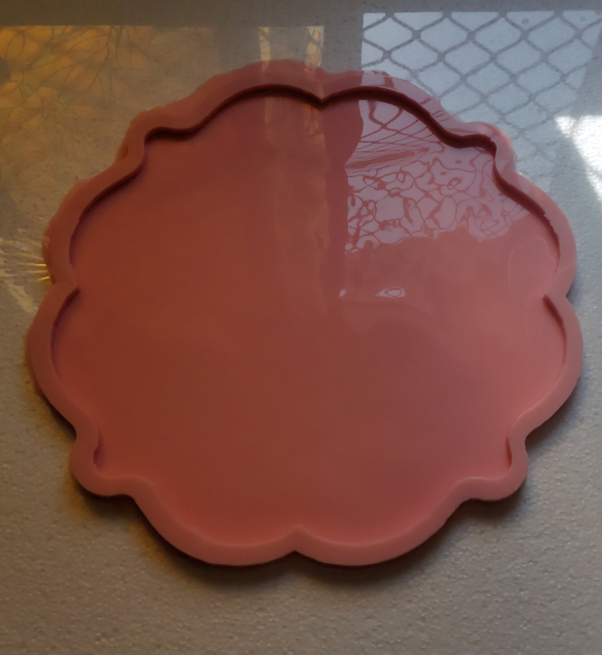 A silicone mold designed for artistic casting work such as resin or plaster, or for making decorative trays. The edges consist of regular curves and waves that give the finished piece an aesthetic appearance. Diameter 35 cm