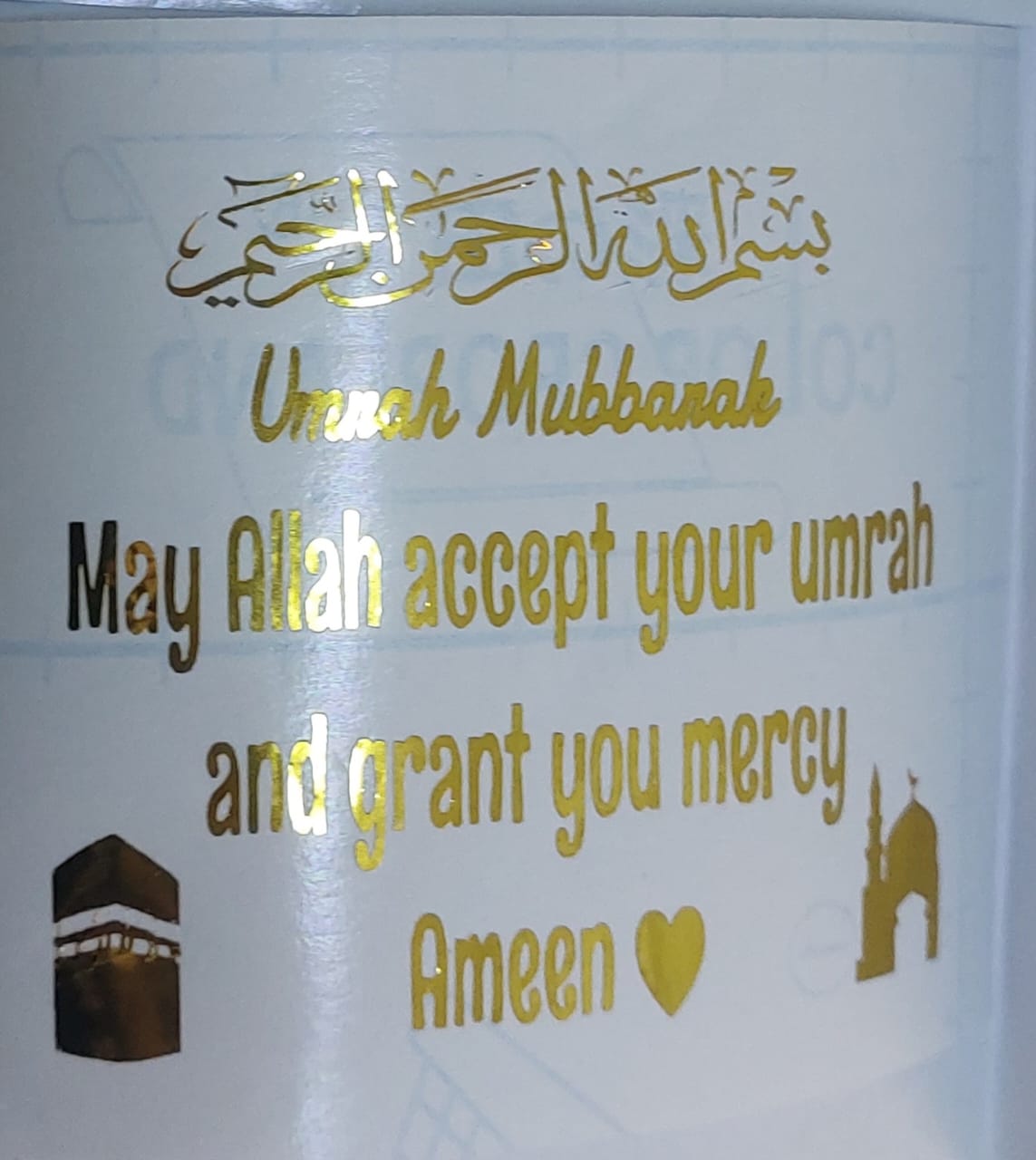 A ready-to-transfer vinyl sticker designed to celebrate a special religious occasion, which is performing the Umrah rituals, and designed in a shiny gold color to offer congratulations and prayers