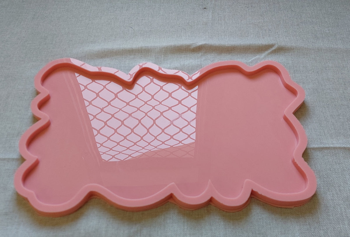 A rectangular silicone mold with irregular, wavy edges, commonly used for making trays and crafts such as casting resin, plaster, or pottery. Dimensions: 37 x 32 cm, Depth: 1 cm