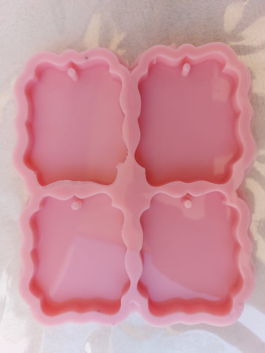 This silicone mold consists of four interconnected, arranged cavities, each rectangular with wavy edges. It is specifically designed for craft projects such as casting resin, polymer clay, wax, or pottery. Size: 6 cm