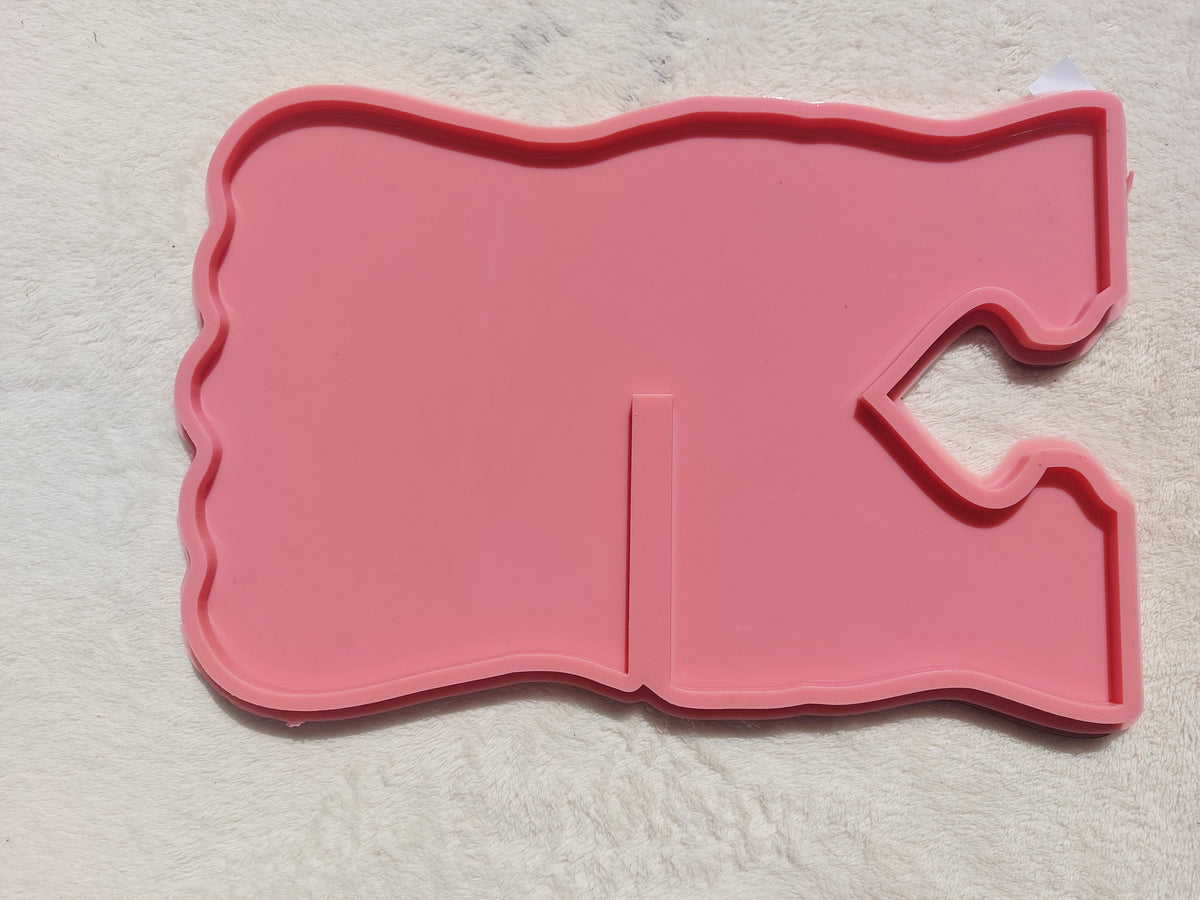 A silicone mold in the shape of a Quran stand designed for casting resin, wax, or pottery. The design features wavy, irregular outer edges, giving the finished piece a modern and attractive look when cast with resin. Available in two different sizes