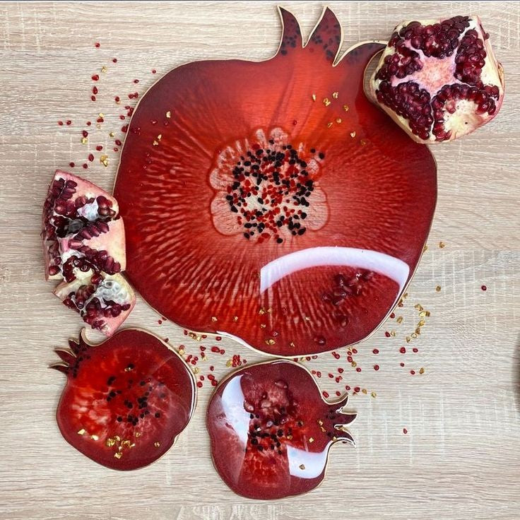 A silicone mold specially designed for crafting projects such as casting resin, polymer clay, wax, or pottery. The mold consists of two connected cavities shaped like a pomegranate, measuring 9 cm in length and 8 mm in depth.