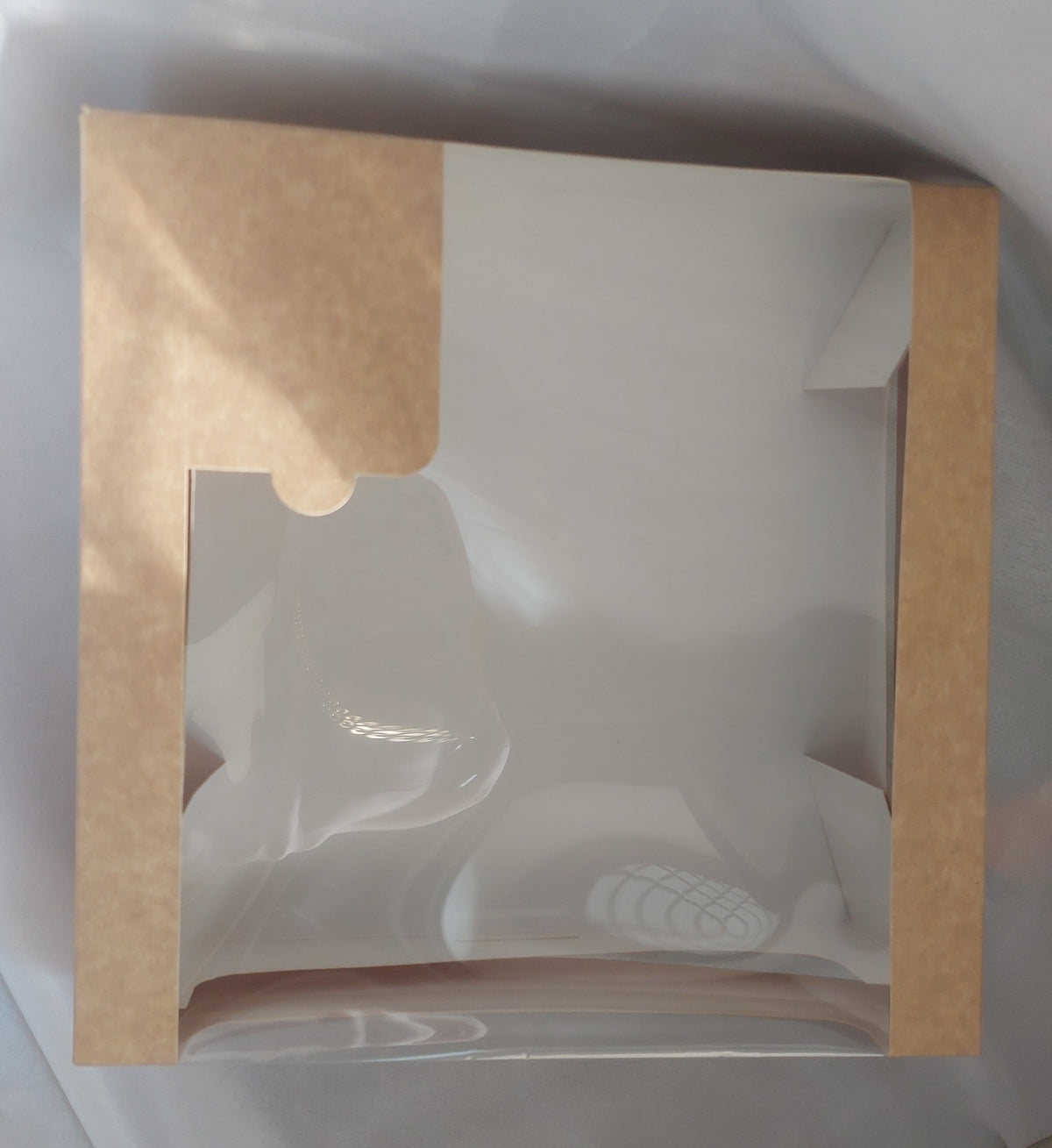 A luxurious and practical collection of packaging boxes made from natural kraft paper, featuring a transparent rectangular window that allows the products inside to be clearly and attractively displayed without the need to open the box
