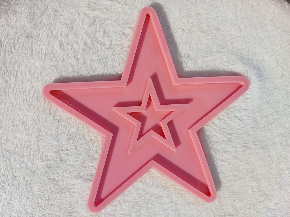 A silicone mold designed in the shape of a classic five-pointed star. Ideal for casting resin, wax, or ceramics; perfect for making coasters or wall decorations size 20 cm