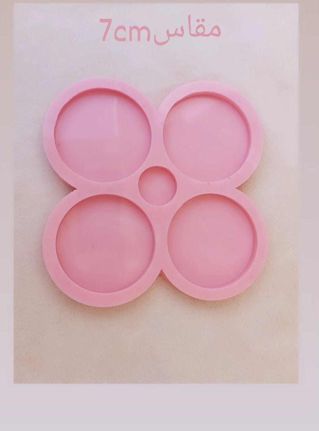 This silicone mold is specially designed for craft projects such as resin, wax, or pottery casting. The mold consists of four interconnected cavities, resembling flower petals, each measuring 7 x 7 cm and 8 mm deep