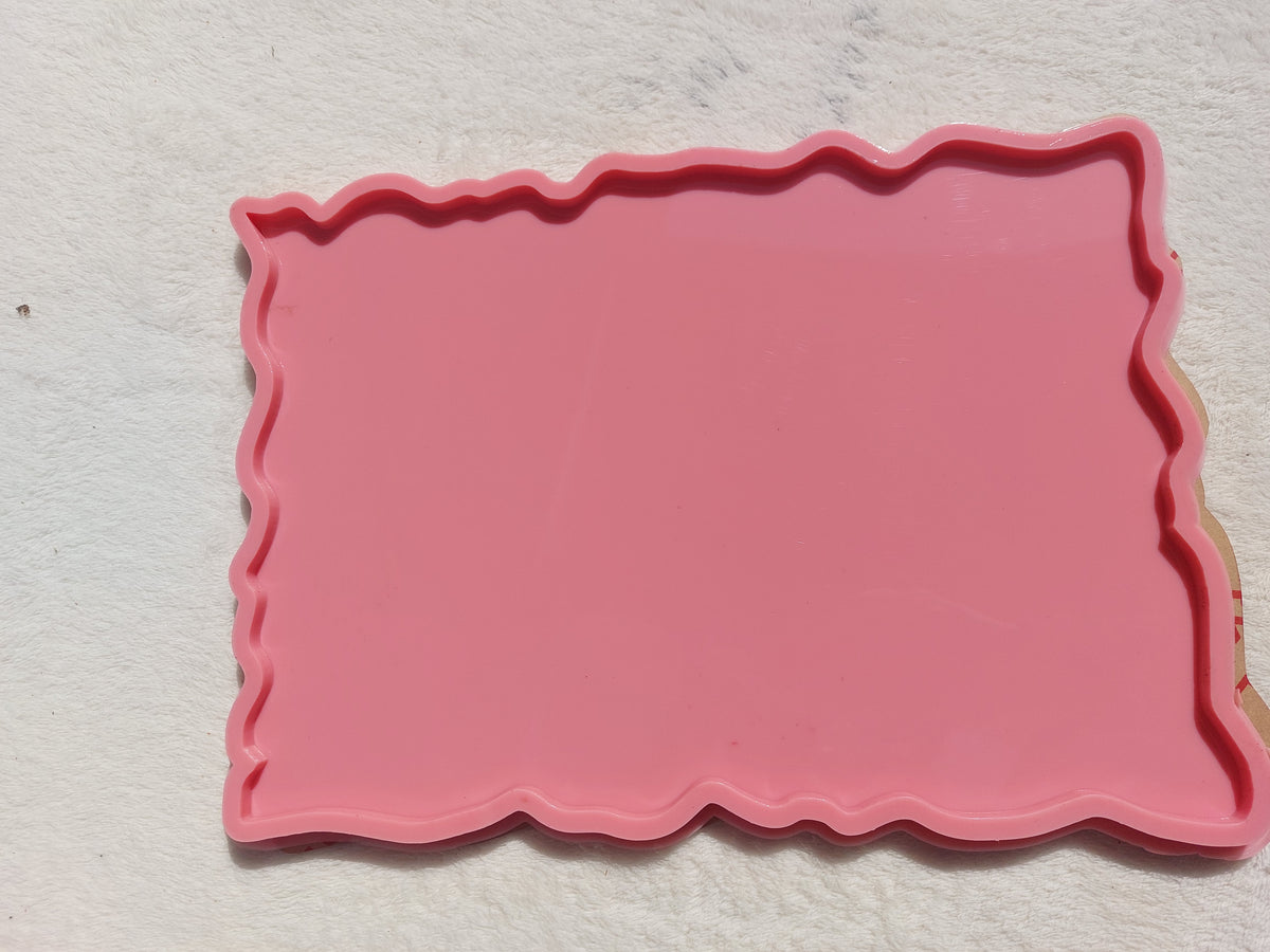 A rectangular silicone mold with irregular, wavy edges, commonly used for making trays and crafts such as casting resin, plaster, or pottery. Dimensions: 30*26 cm, Depth: 8 mm