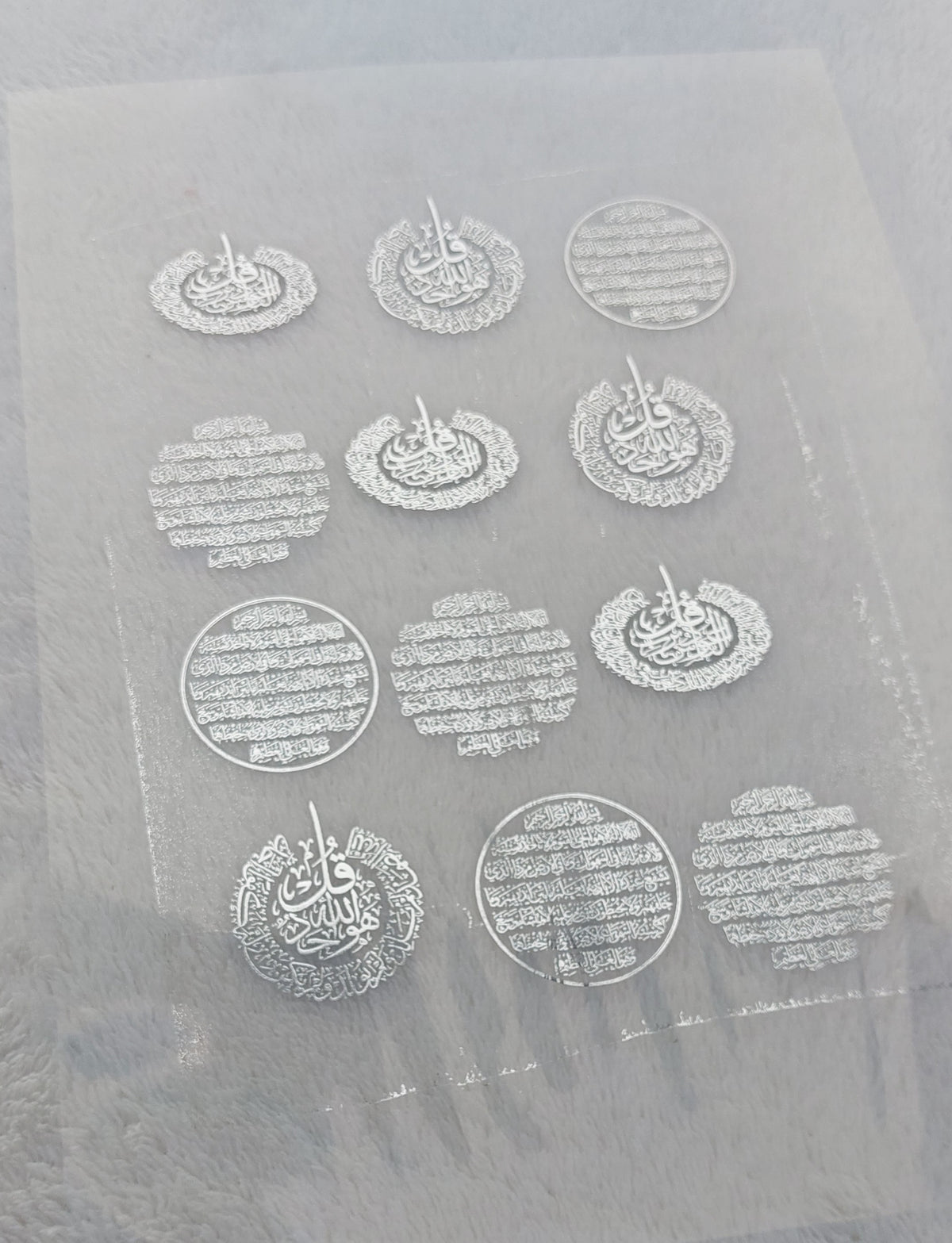 Transparent printed paper or stickers containing Quranic verses and prayers. This type of repeated text is used to be placed inside the included resin molds, or to be glued onto car pendants and medals as handicrafts