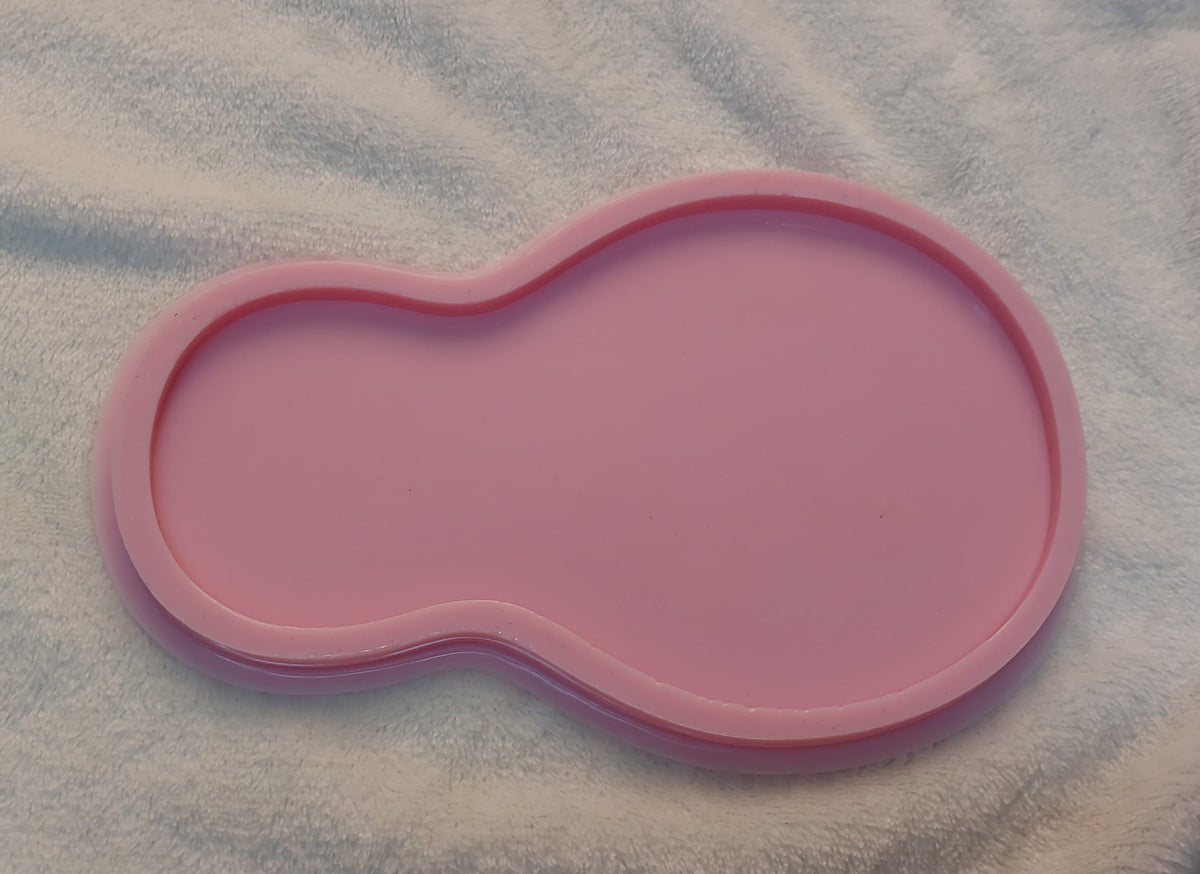 This silicone mold features a curved design consisting of two connected circular parts: a smaller part on the left and a much larger part on the right, resembling a pear or the number 8. The total width is 42mm and the depth is 8mm.
