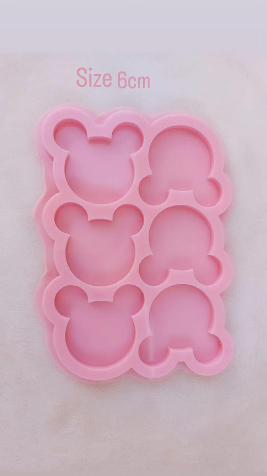 A silicone mold specially designed for crafting projects such as casting resin, wax, pottery, or polymer clay. The mold contains 6 interconnected cavities, taking the shape of the head of the famous cartoon character "Mickey Mouse," measuring 6 cm.