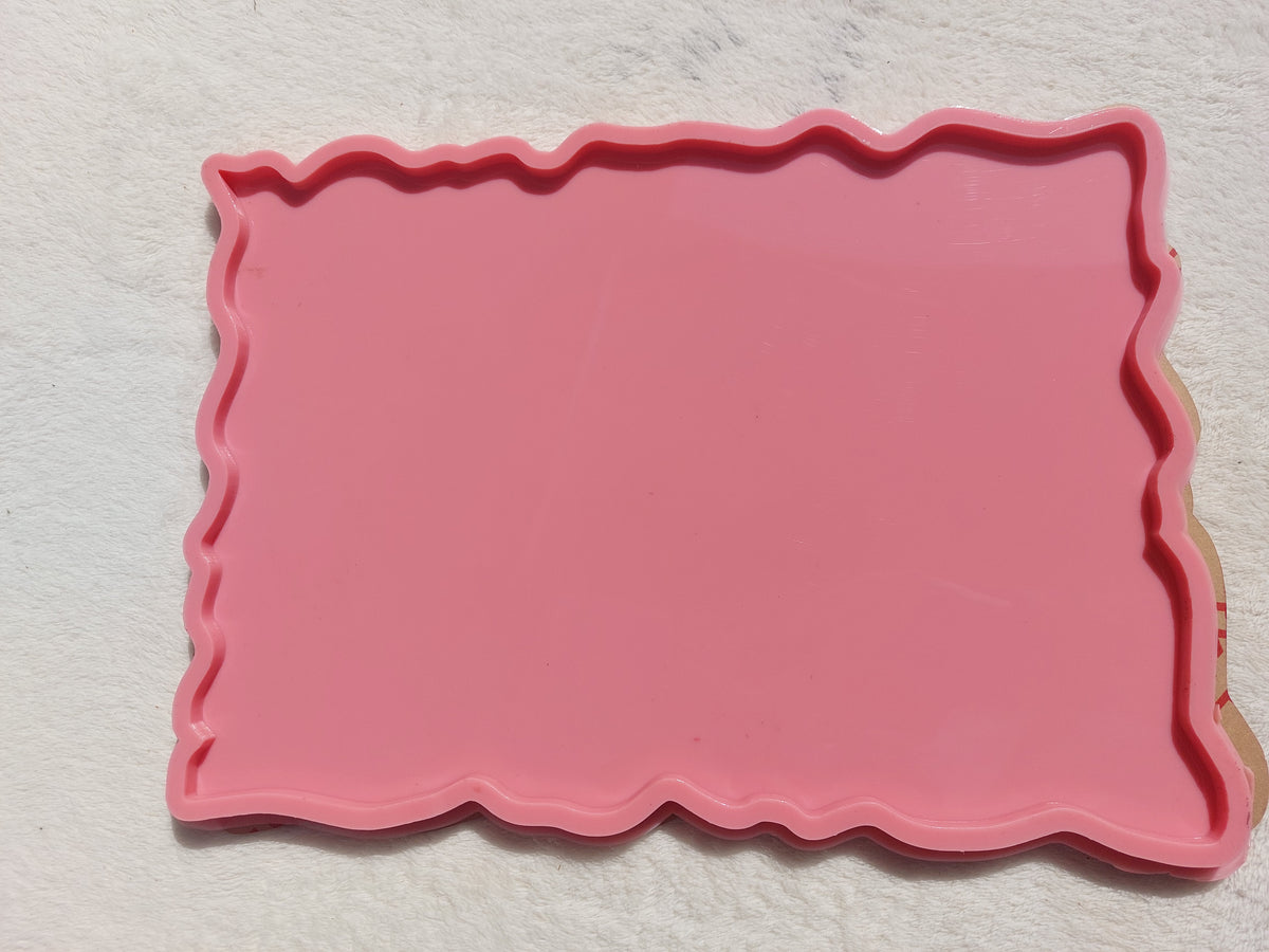 A rectangular silicone mold with irregular, wavy edges, commonly used for making trays and crafts such as casting resin, plaster, or pottery. Dimensions: 30*26 cm, Depth: 8 mm