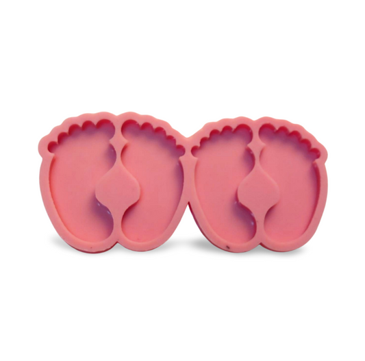 A silicone mold specially designed for crafting projects such as casting resin, polymer clay, wax, or pottery, used to make keychains, designed in the shape of pairs of tiny baby feet.