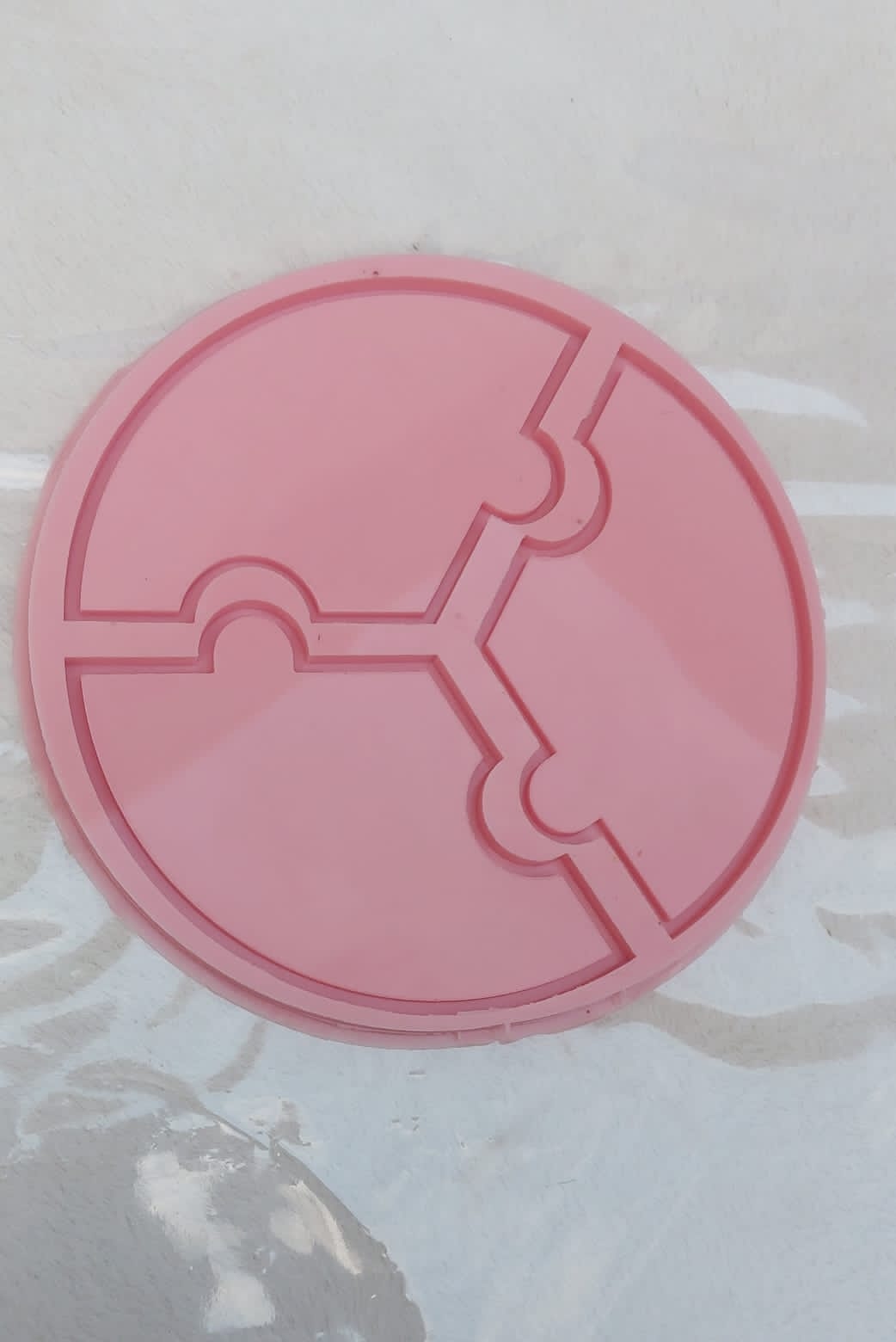 A round silicone mold with an internal cavity divided into three equal parts, designed for crafting projects such as resin casting, pottery, or wax work. Size: 25 cm