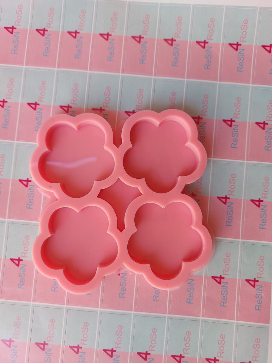 A silicone mold designed for crafts such as casting resin, polymer clay, or wax. It features four interconnected cavities, each designed in the shape of a five-petaled rose with smooth, rounded edges. Size: 5 cm