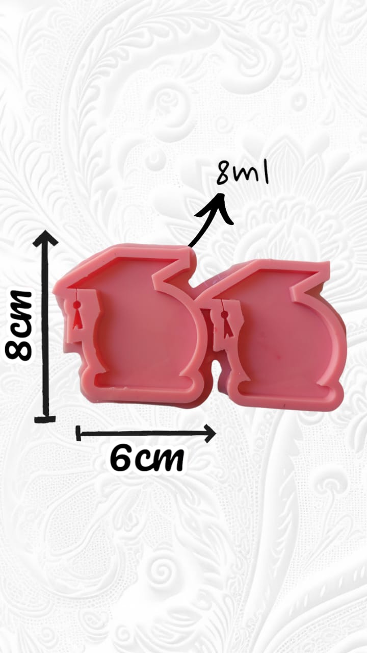 A silicone mold designed for crafts such as resin casting, polymer clay, or wax. The mold has two connected cavities, each designed in the shape of a graduation cap. Size: 8*6 cm