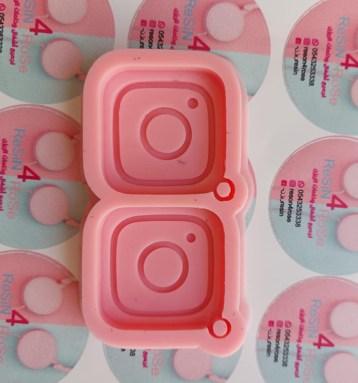A modern, social media-inspired silicone mold with two connected cavities, each designed in the shape of an Instagram icon. Dimensions: 5x5 cm