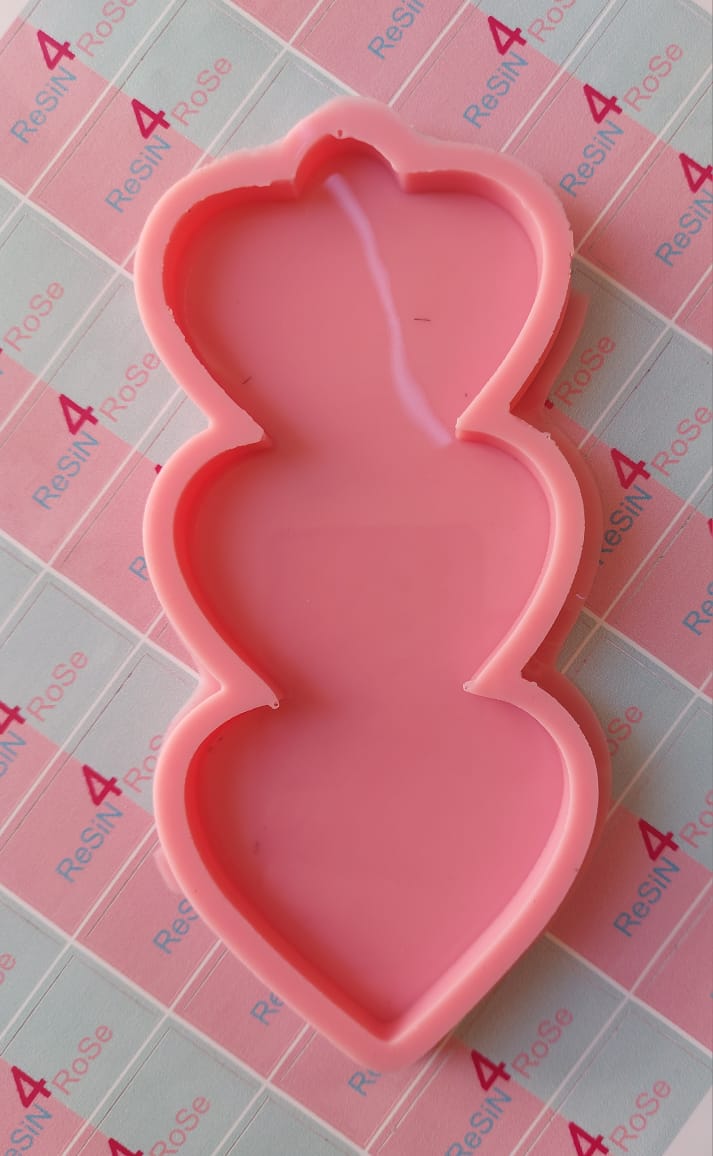 A silicone mold with a single cavity containing three vertically connected cores. Used for casting resin, plaster, or wax. Dimensions: 16 x 7 cm.