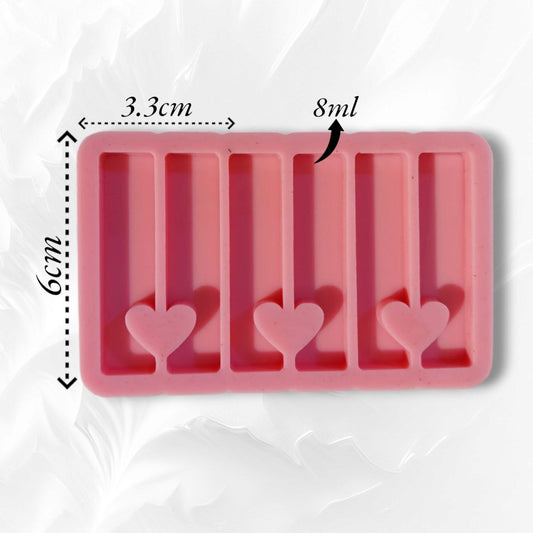 A rectangular silicone mold with multiple, organized cavities and a heart-shaped opening connecting each pair of adjacent rectangles, designed for casting resin, wax, or plaster. Dimensions: 3.3 x 6 cm.