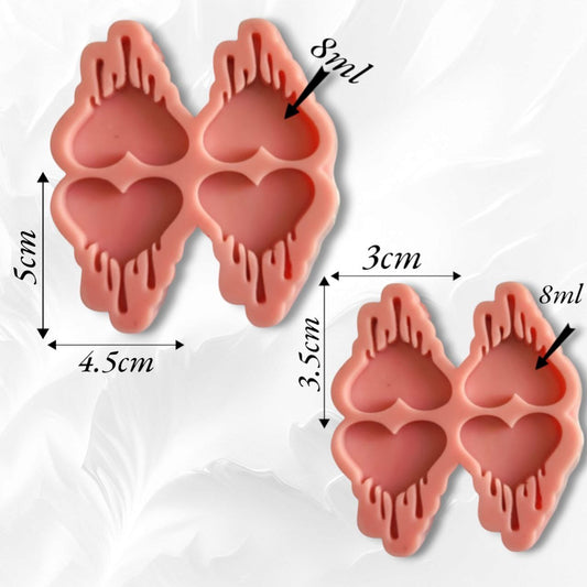 A silicone mold containing four heart-shaped cavities with melting or dripping lines emerging from its upper and lower edges. The design is modern and unconventional, making it a great choice for those who love to stand out in handicrafts