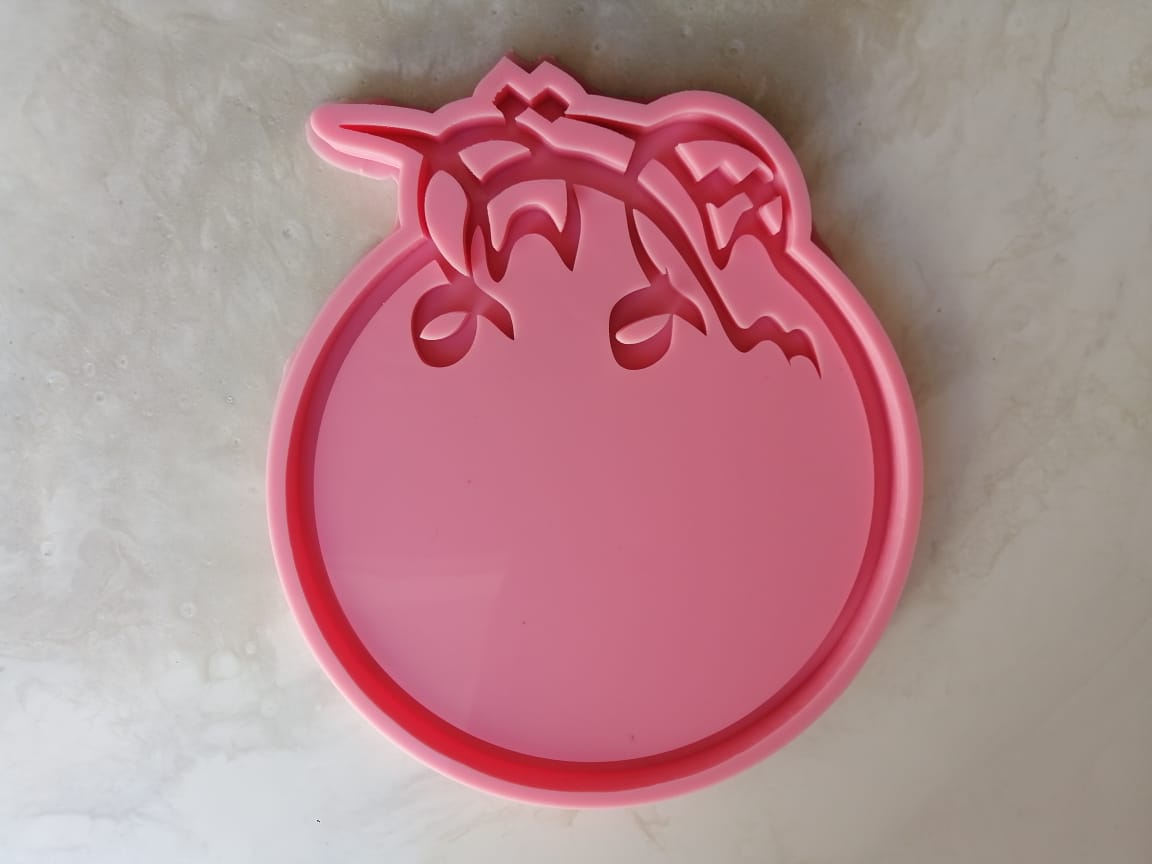 This silicone mold features a circular design with the words "Happy Eid" written in Arabic script on the bottom. It can be used for resin, pottery, or wax.