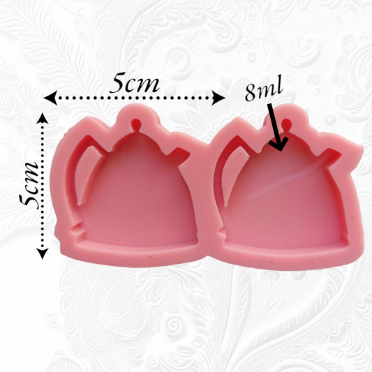 This silicone mold has two interconnected cavities, each designed in the shape of a teapot. This mold allows you to produce multiple identical pieces simultaneously with a small amount of material. Dimensions: 5 x 5 cm, Depth: 8 mm