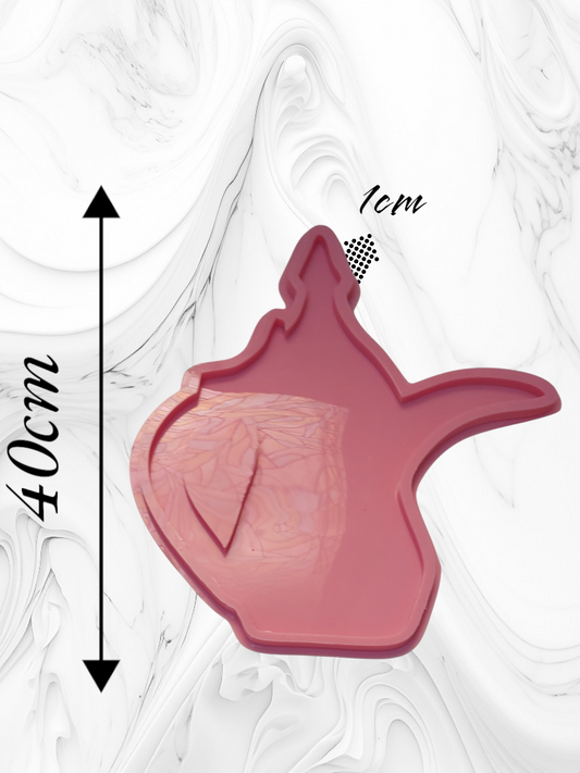 A silicone mold in a traditional style, resembling a coffee pot, featuring a deep inner cavity and a raised outer edge for shaping the figure when casting materials such as resin, plaster, or pottery. Dimensions: 40 cm, Depth: 1 cm