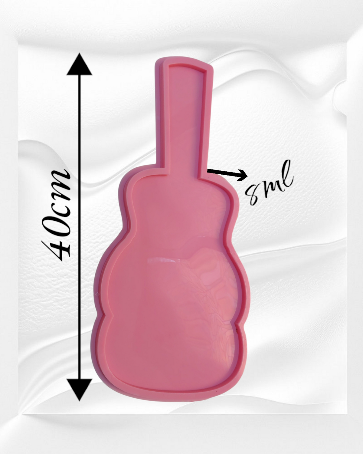 A silicone mold used for resin, wax, or pottery, designed in the shape of a guitar, has a prominent outer edge and an inner cavity, emphasizing its nature as a casting mold The mold is 40 cm long and 8 mm deep.