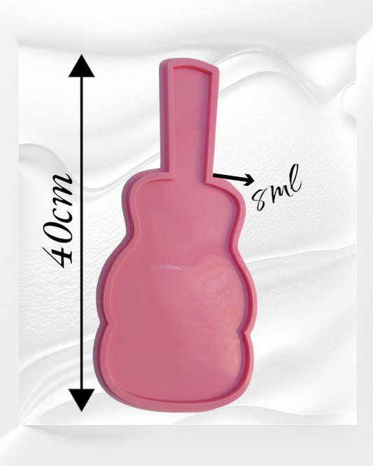 A silicone mold used for resin, wax, or pottery, designed in the shape of a guitar, has a prominent outer edge and an inner cavity, emphasizing its nature as a casting mold The mold is 40 cm long and 8 mm deep.