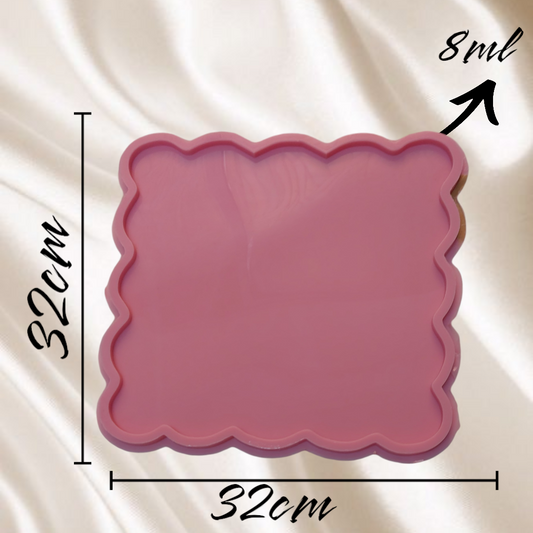 A square-shaped silicone mold with regular wavy edges, containing a flat inner cavity surrounded by a raised, protruding frame, available in 4 different sizes.