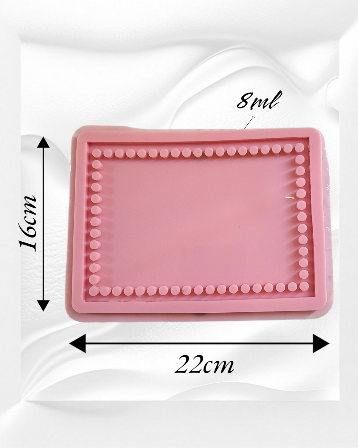 A light pink silicone mold featuring a unique design with an inner frame of small raised circles surrounding the flat area in the center. Length: 22 cm, Width: 16 cm, Depth: 8 mm