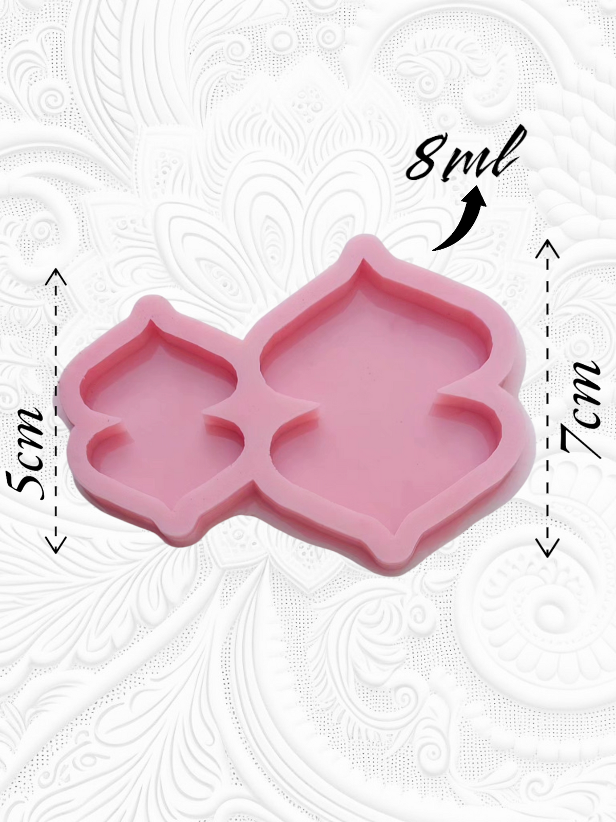 A silicone mold with two separate cavities, each shaped like a symmetrical arch or dome with pointed corners at the top and bottom. It is used for casting resin, wax, or ceramics, and can be used to make medals, car charms, earrings, or decorative items.