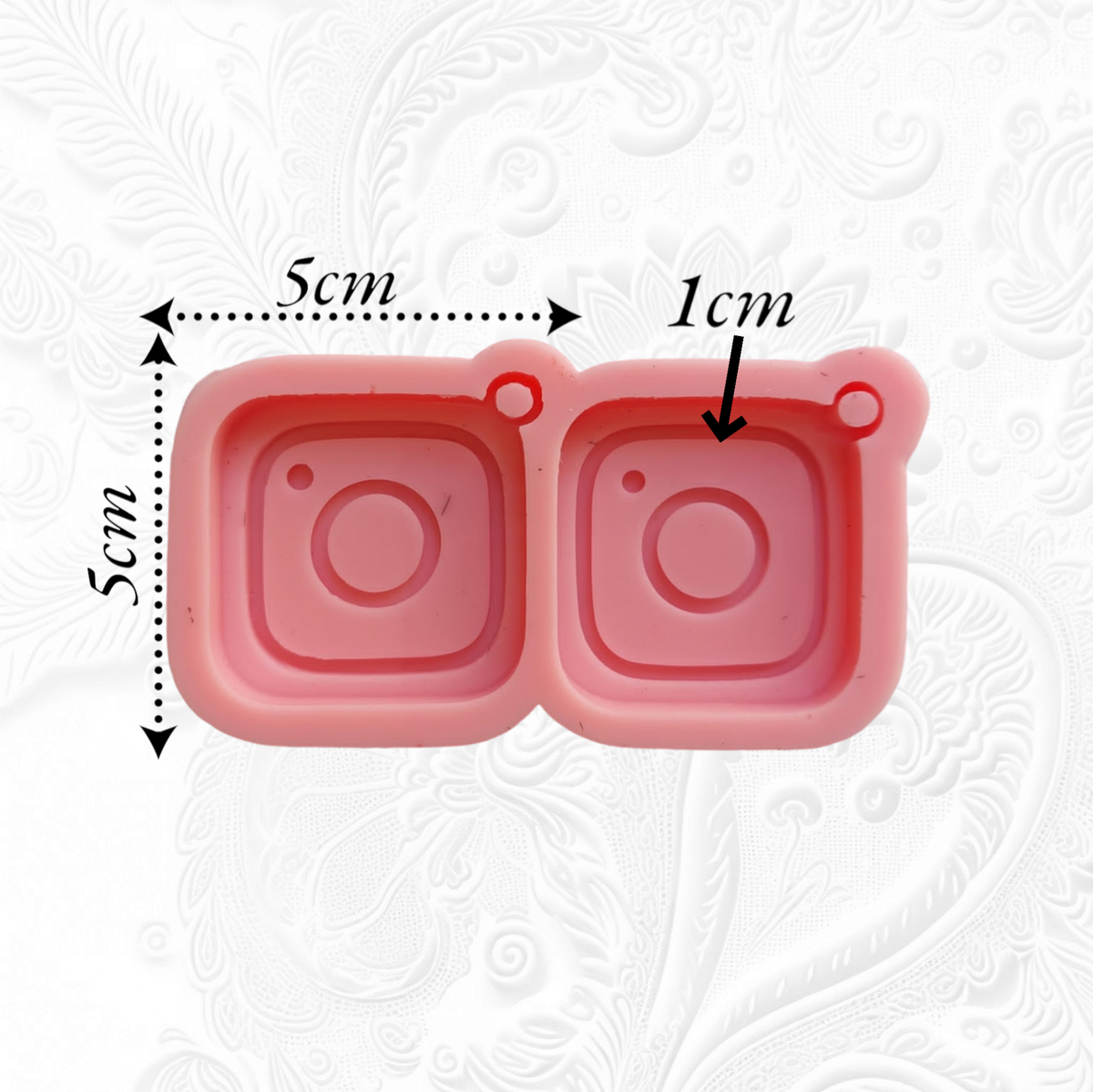 A modern, social media-inspired silicone mold with two connected cavities, each designed in the shape of an Instagram icon. Dimensions: 5x5 cm