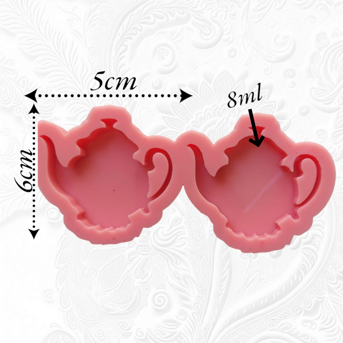 This silicone mold has two interconnected cavities, each designed in the shape of a teapot. This mold allows you to produce multiple identical pieces simultaneously with a small amount of material. Dimensions: 5 x 6 cm, Depth: 8 mm