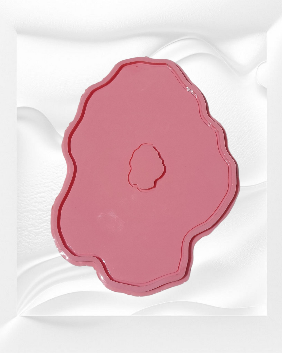 This silicone mold features an irregular, organic design that mimics the wavy edges of natural gemstones or stone slabs. It has a wide, flat main cavity with a small, irregularly shaped protrusion in the center.
