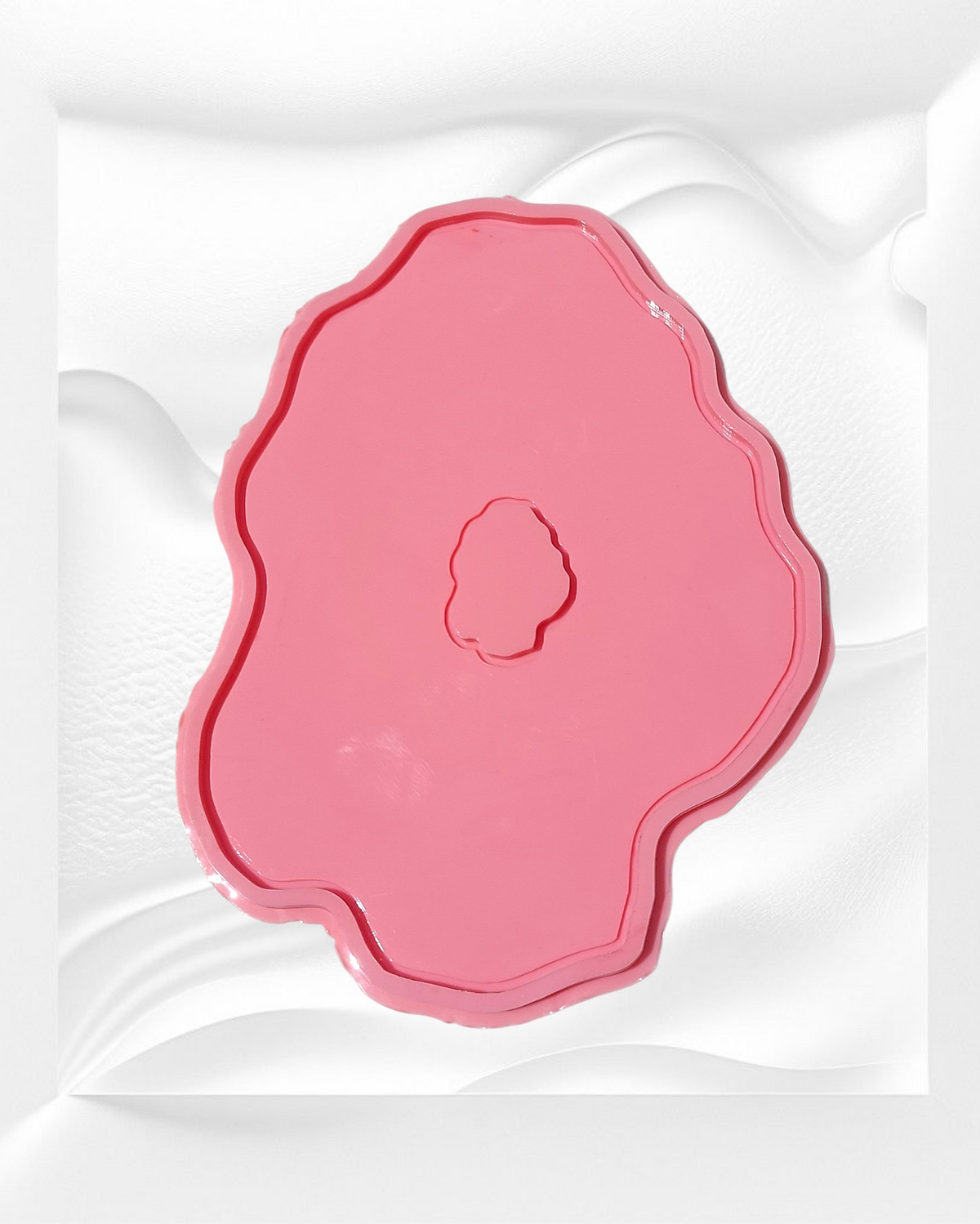 This silicone mold features an irregular, organic design that mimics the wavy edges of natural gemstones or stone slabs. It has a wide, flat main cavity with a small, irregularly shaped protrusion in the center.