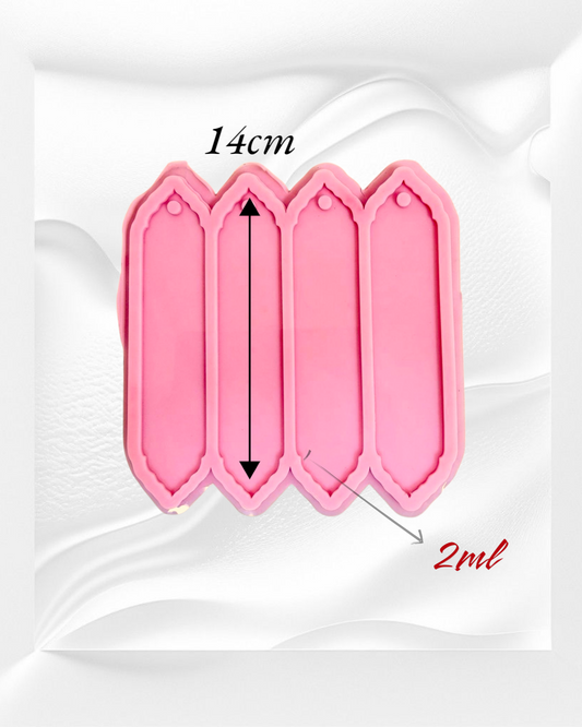 A silicone mold with four identical, elongated rectangular cavities designed to create decorative elongated shapes, ideal for use as bookmarks or decorative pieces. Cavity length: 14 cm
