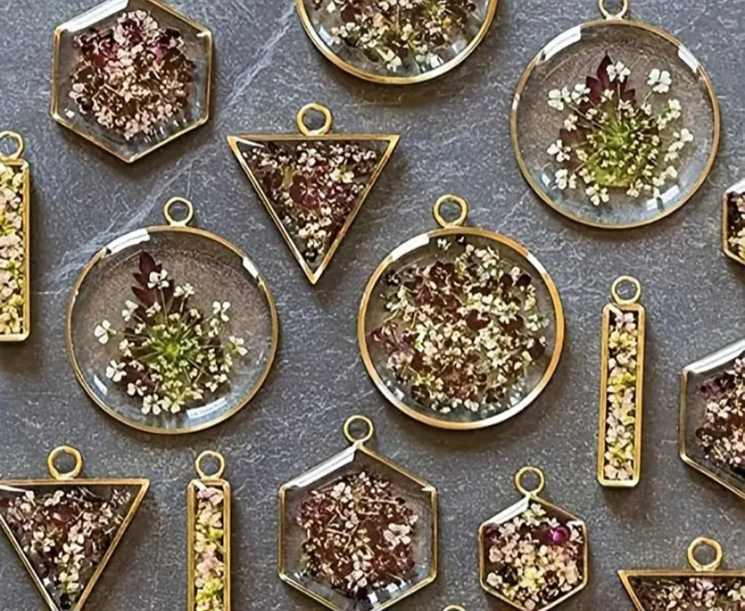 A set of open metal resin frames, which are hollow metal molds used primarily in the manufacture of jewelry and medals using resin