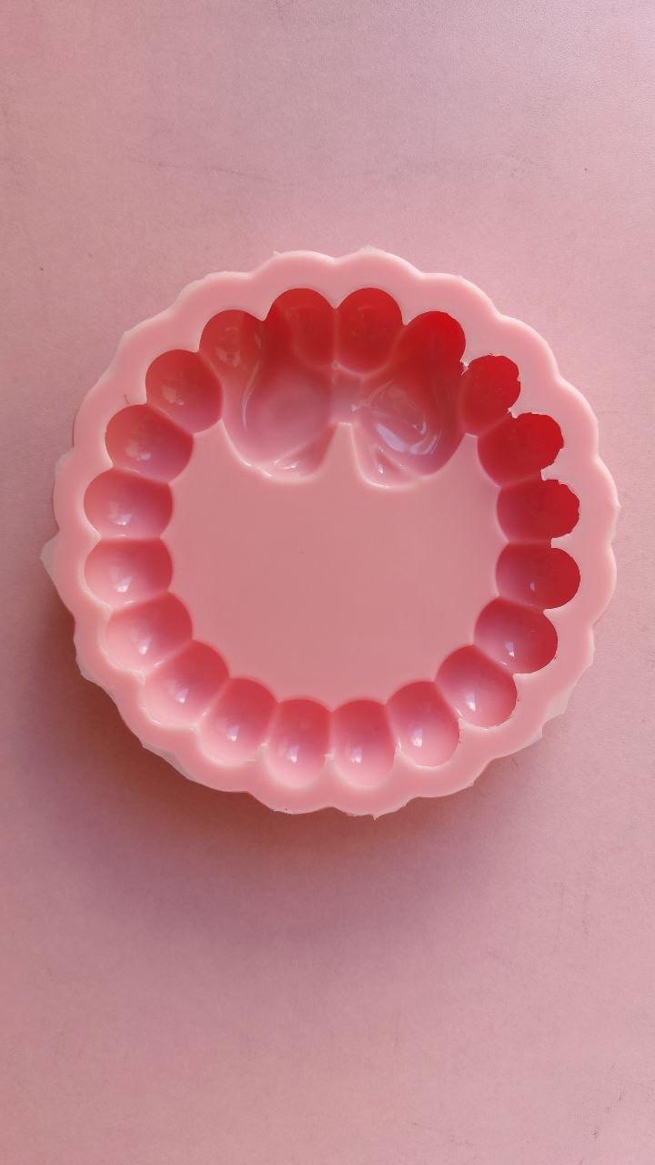 A pink silicone mold with large edges, primarily intended for crafts