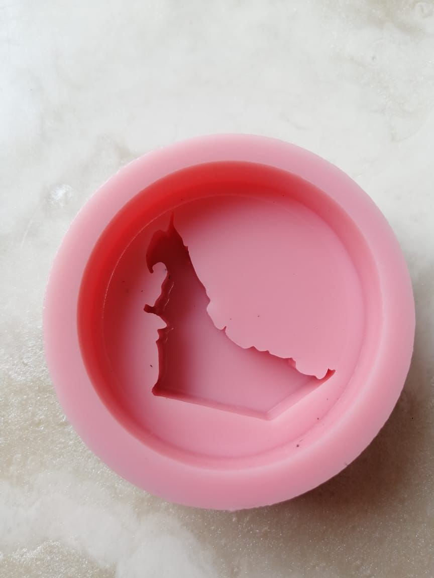 Round silicone mold with a raised map of the UAE, suitable for making resin or concrete pendants, scented soaps, and fragrant mastic.