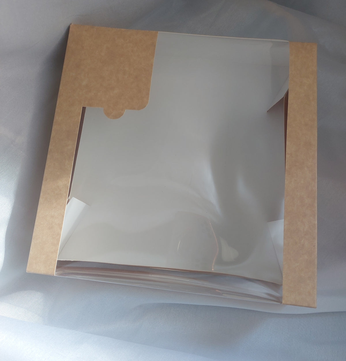 A luxurious and practical collection of packaging boxes made from natural kraft paper, featuring a transparent rectangular window that allows the products inside to be clearly and attractively displayed without the need to open the box