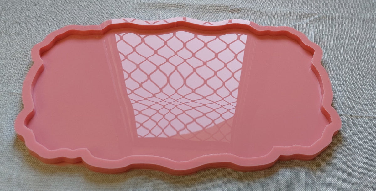 A rectangular silicone mold with wavy and curved edges, ideal for artwork such as resin, candles, or pottery. Available in two different sizes.