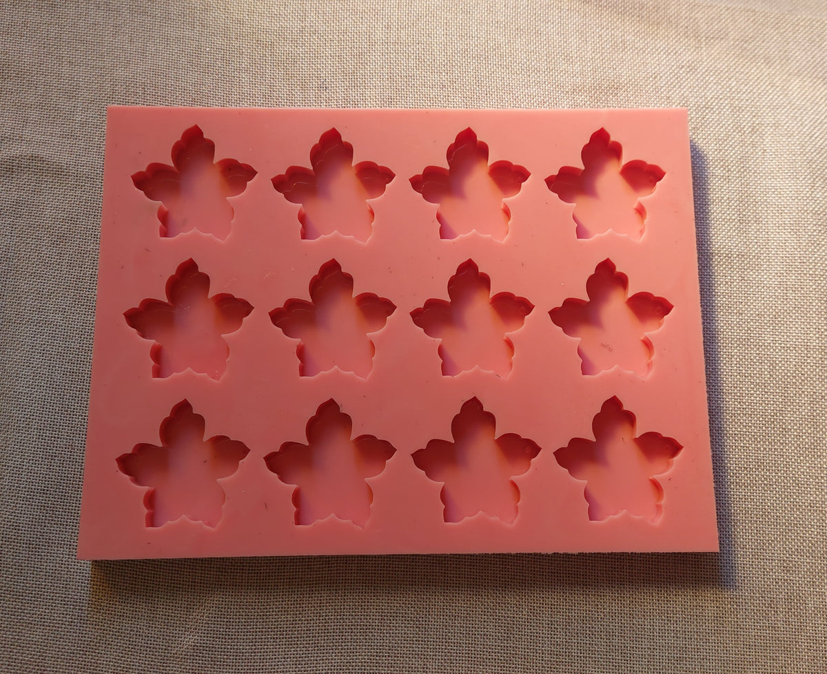 A silicone mold containing a variety of small, rose-shaped cavities, ideal for resin, wax, pottery, or craft projects, and used for making keychains .size 5 cm