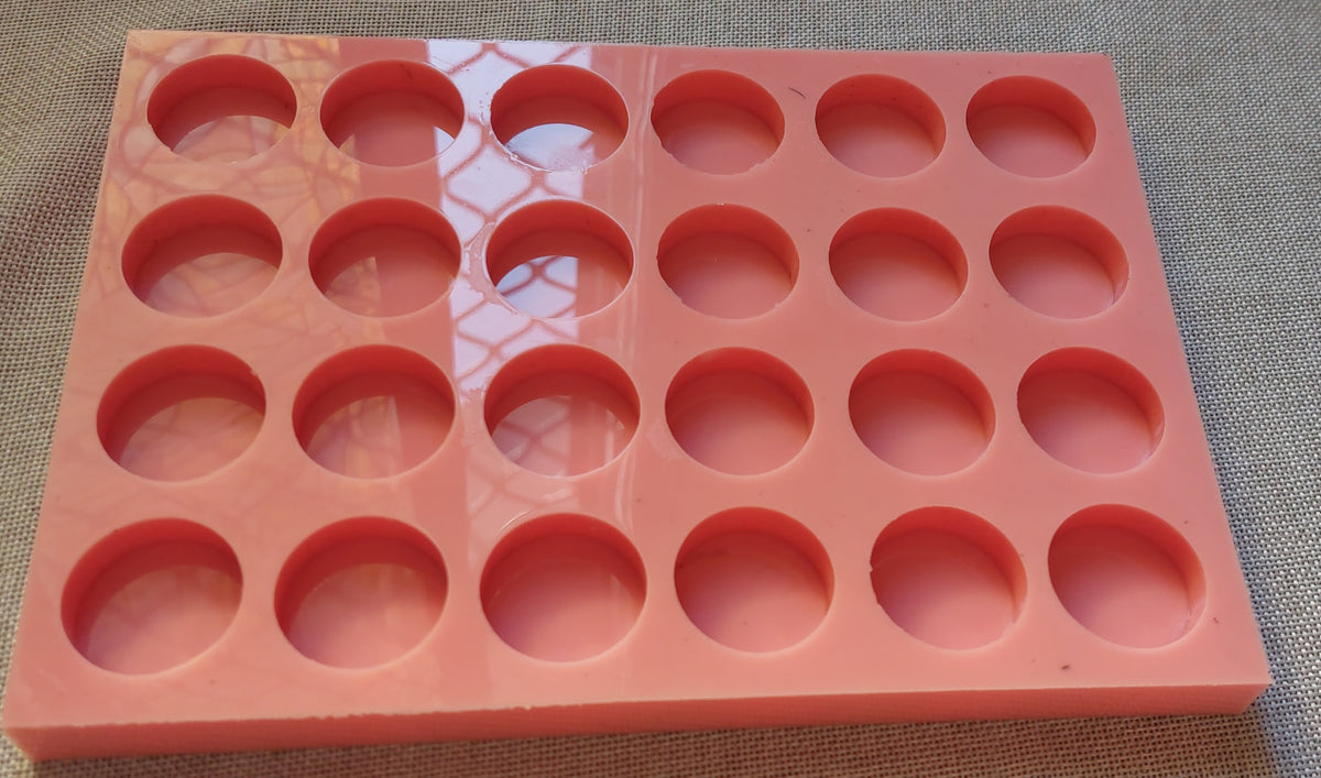 A silicone mold designed for resin, wax, pottery, or craft work. The mold contains 24 equal-sized circular cavities, regularly distributed in 4 rows and 6 columns.