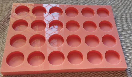 A silicone mold designed for resin, wax, pottery, or craft work. The mold contains 24 equal-sized circular cavities, regularly distributed in 4 rows and 6 columns.