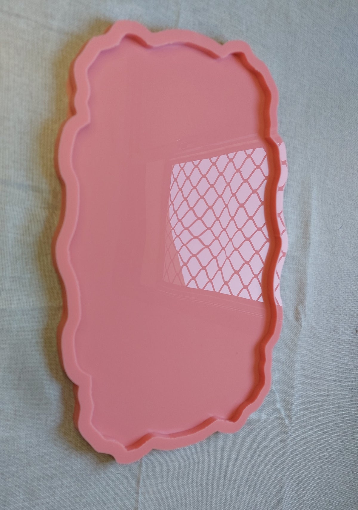 A rectangular silicone mold with wavy and curved edges, ideal for artwork such as resin, candles, or pottery. Available in two different sizes.