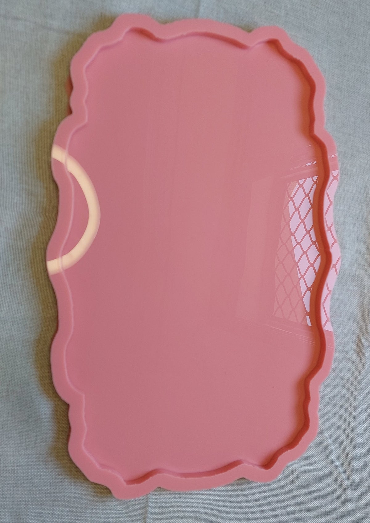 A rectangular silicone mold with wavy and curved edges, ideal for artwork such as resin, candles, or pottery. Available in two different sizes.