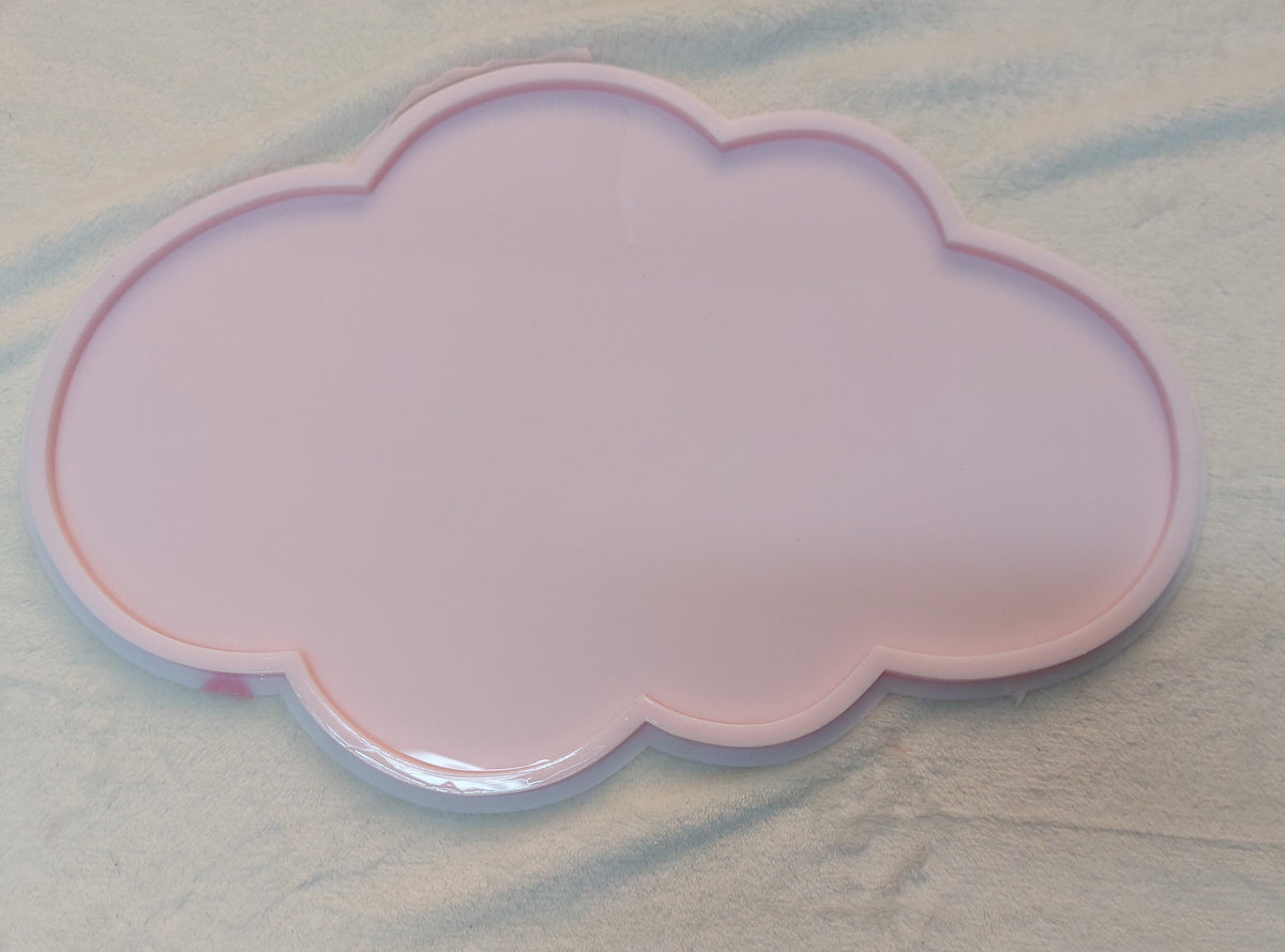A silicone mold shaped like a cute cloud with interconnected circular curves. It features a wide, flat inner cavity surrounded by a raised, protruding frame to define the cloud shape when poured. Dimensions: 42cm x 25cm, Height: 8ml