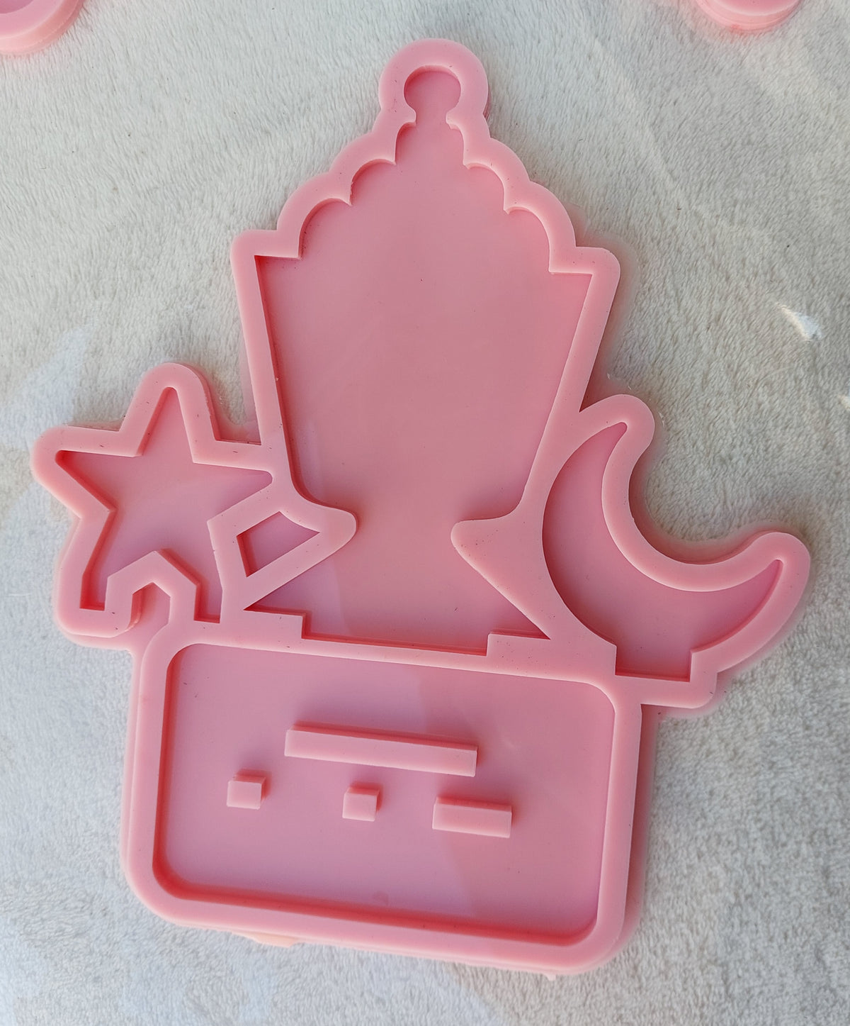 This silicone mold features three separate shapes: a traditional lantern in the center, a five-pointed star on the left, and a crescent moon on the right. It is suitable for casting resin, wax, plaster, or ceramics. size is 15*9 cm