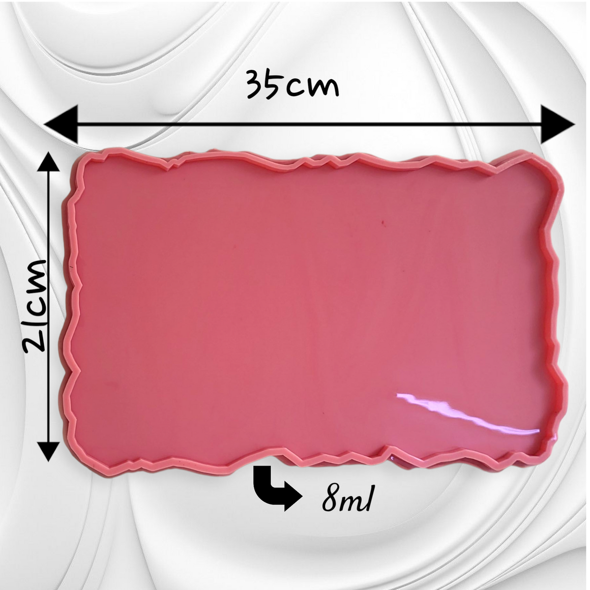 This silicone mold features a rectangular shape with irregular, serrated edges, giving the cast piece a natural appearance resembling gemstones or raw marble. It is suitable for resin, wax, or ceramics. Dimensions: 35 x21 cm, Depth: 8 mm