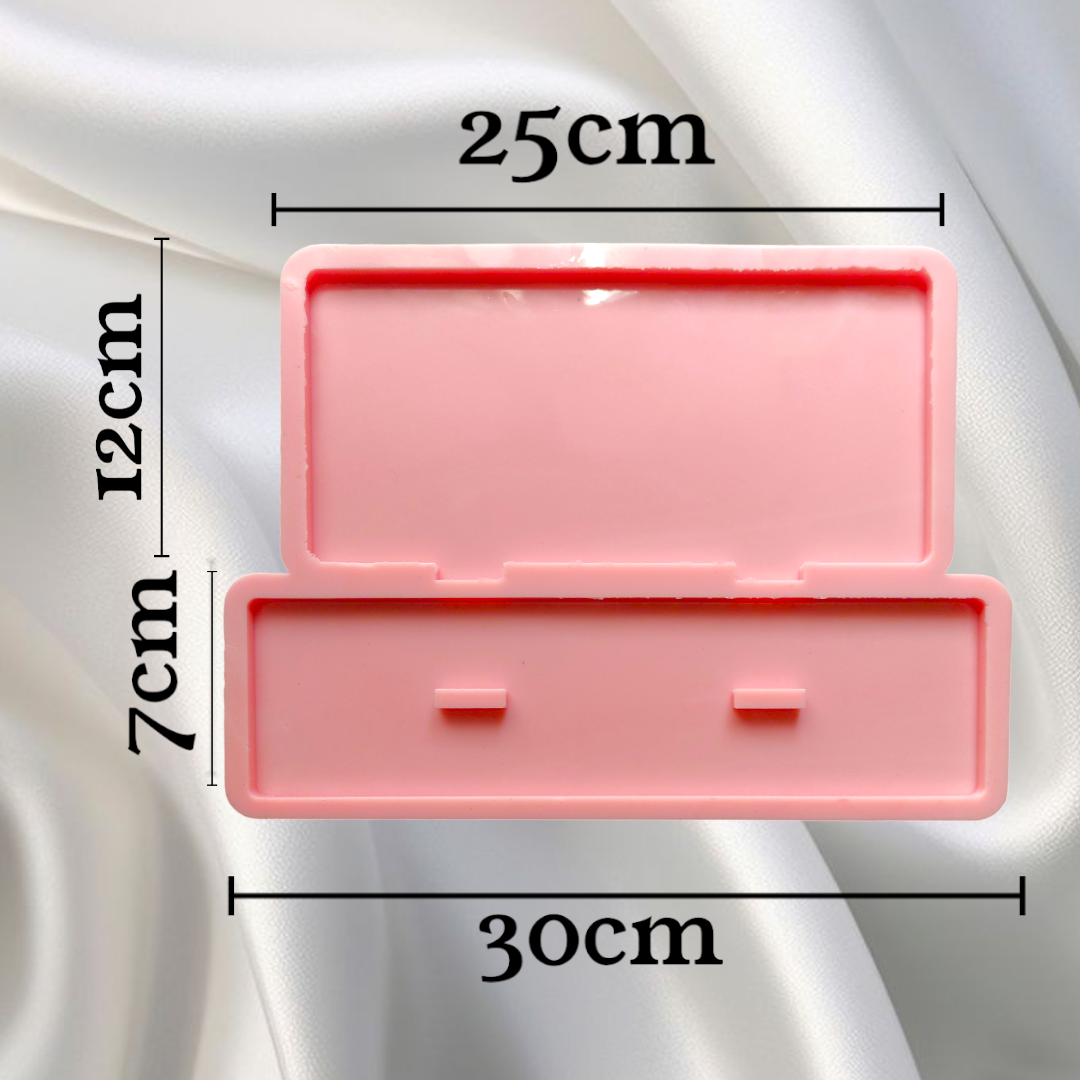 A silicone mold designed for casting art pieces consisting of two parts (base and back panel). It is used to make desk plaques, desk calendars, welcome plaques, decorations, earring organizers, or accessories. Available in two different sizes